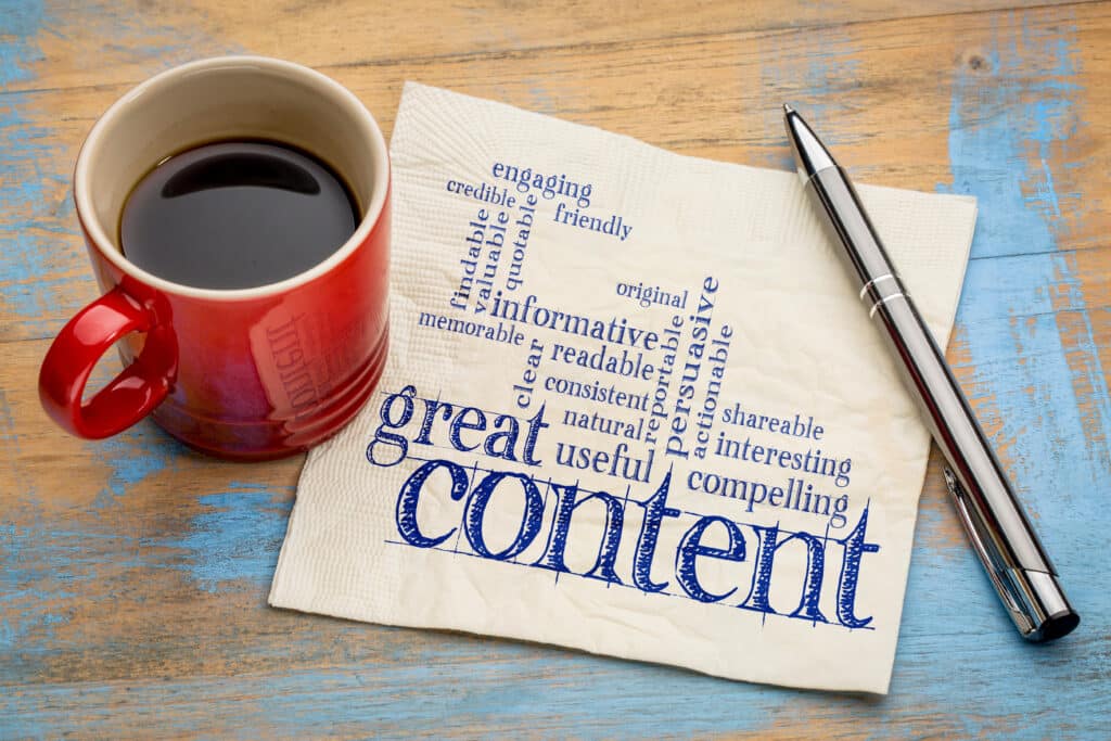 coffee cup with napkin that has a word cloud on it saying things like "great content" and other ways to gain attention in a writing piece.