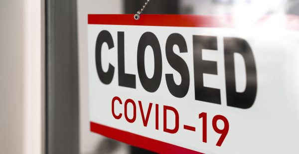 Closed businesses for COVID-19 pandemic outbreak, closure sign on retail store window banner background. Government shutdown of restaurants, shopping stores, non essential services.